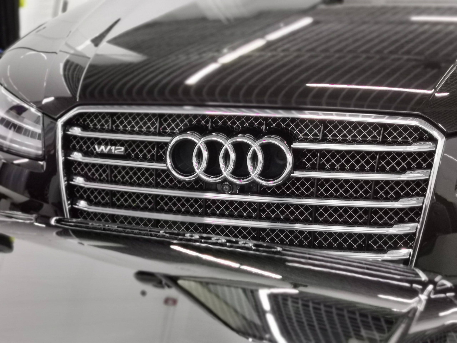 Решётка Audi W12 и отражения студийного света на кузове